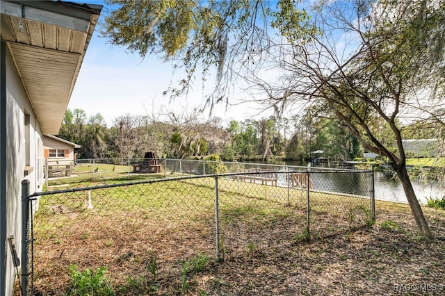 view of yard featuring a water view and fence