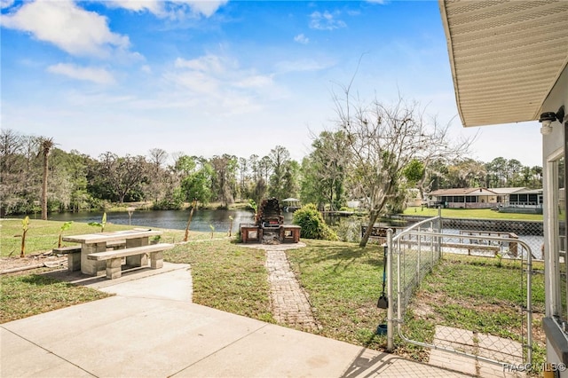 view of yard with a water view and fence