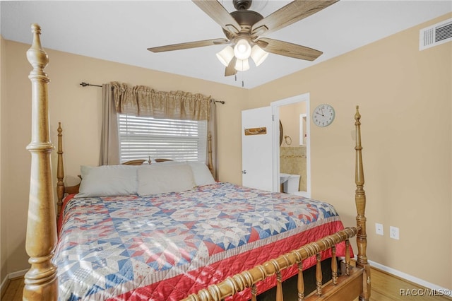 bedroom featuring ceiling fan, connected bathroom, wood finished floors, visible vents, and baseboards