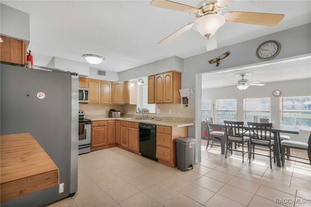 kitchen featuring a textured ceiling, visible vents, stainless steel appliances, and light countertops