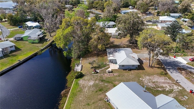 birds eye view of property with a water view and a residential view