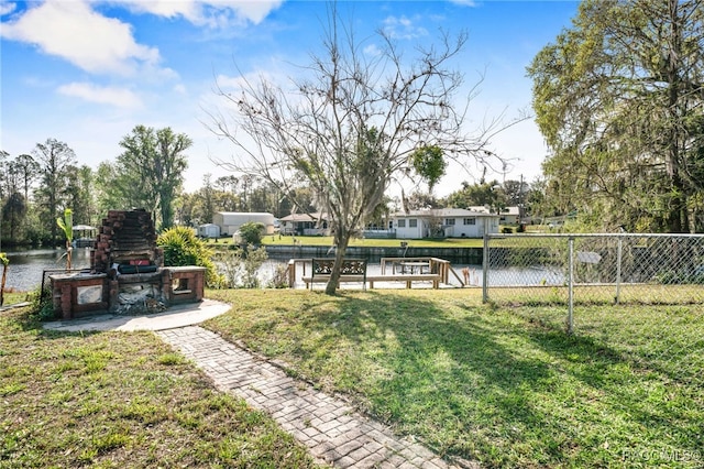 view of yard featuring a water view and fence