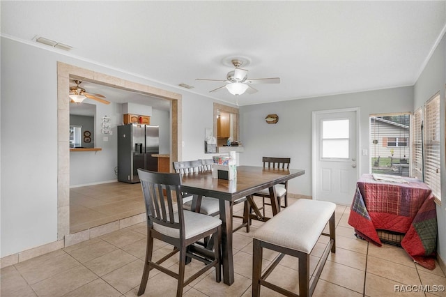 dining room with ceiling fan, light tile patterned flooring, visible vents, and baseboards