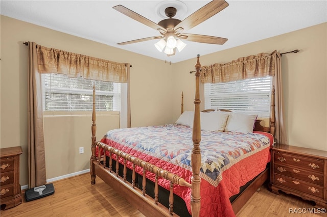 bedroom with ceiling fan, baseboards, and wood finished floors