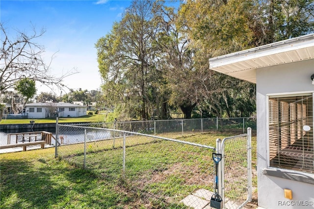 view of yard featuring a water view and fence