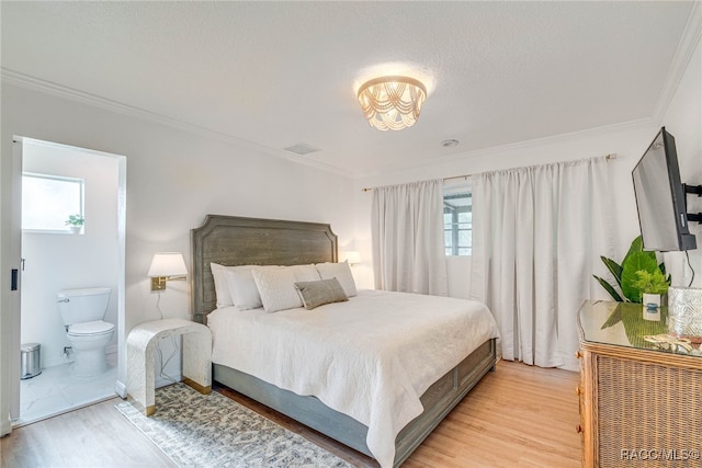 2310 N Watersedge Dr, Crystal River, FL 34429 - bedroom featuring light wood-type flooring, ornamental molding, and connected bathroom