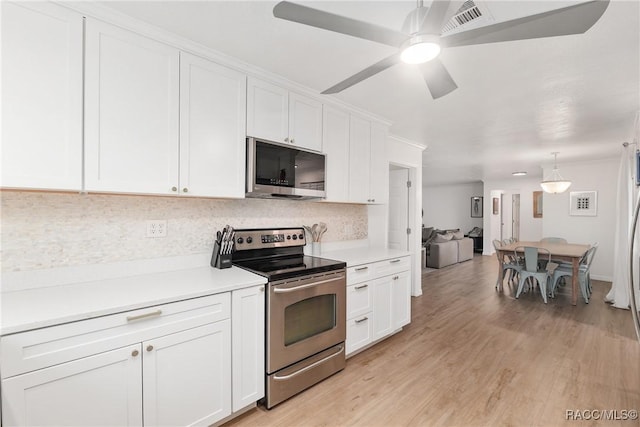 2310 N Watersedge Dr, Crystal River, FL 34429 - kitchen featuring stainless steel appliances, decorative backsplash, white cabinetry, and light countertops