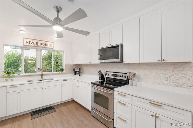 2310 N Watersedge Dr, Crystal River, FL 34429 - kitchen featuring stainless steel appliances, tasteful backsplash, light countertops, white cabinets, and light wood-style floors