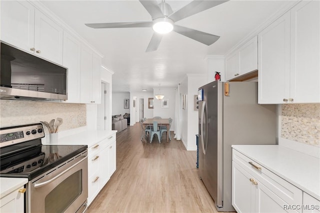 2310 N Watersedge Dr, Crystal River, FL 34429 - kitchen featuring stainless steel appliances, decorative backsplash, white cabinets, and light countertops