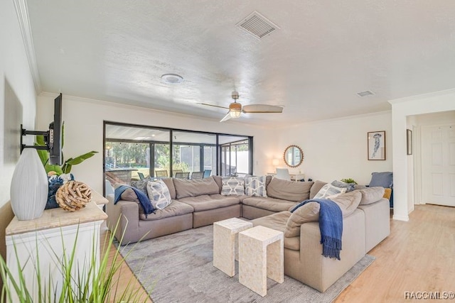 2310 N Watersedge Dr, Crystal River, FL 34429 - living area with ornamental molding, a ceiling fan, and light wood finished floors