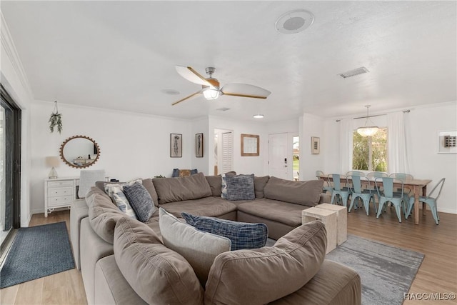 2310 N Watersedge Dr, Crystal River, FL 34429 - living area featuring light wood-style flooring, ornamental molding, and ceiling fan