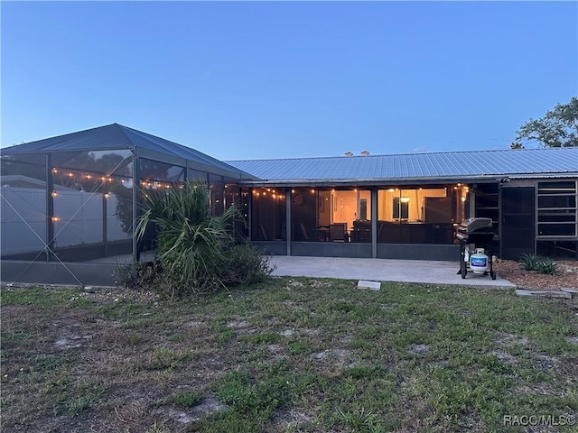2310 N Watersedge Dr, Crystal River, FL 34429 - rear view of house with a yard, a metal roof, and a lanai