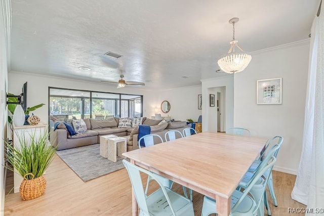 2310 N Watersedge Dr, Crystal River, FL 34429 - dining area featuring light wood finished floors, ornamental molding, and a ceiling fan
