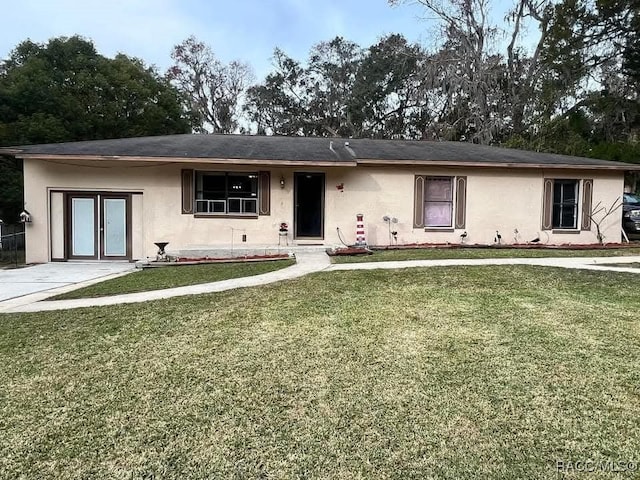 ranch-style house with a front lawn and stucco siding