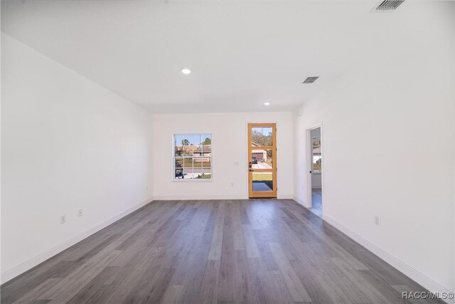 8589 N Sumter Ter, Dunnellon, FL 34433 - spare room featuring dark wood-style flooring and recessed lighting