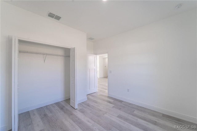 8589 N Sumter Ter, Dunnellon, FL 34433 - unfurnished bedroom with light wood finished floors and a closet