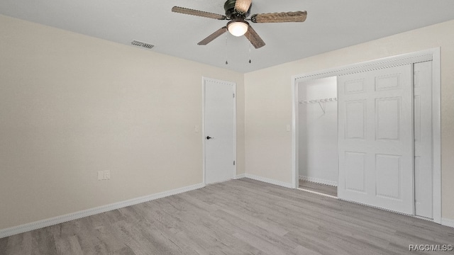 unfurnished bedroom featuring ceiling fan, a closet, and light hardwood / wood-style flooring