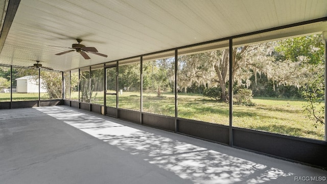 unfurnished sunroom featuring ceiling fan