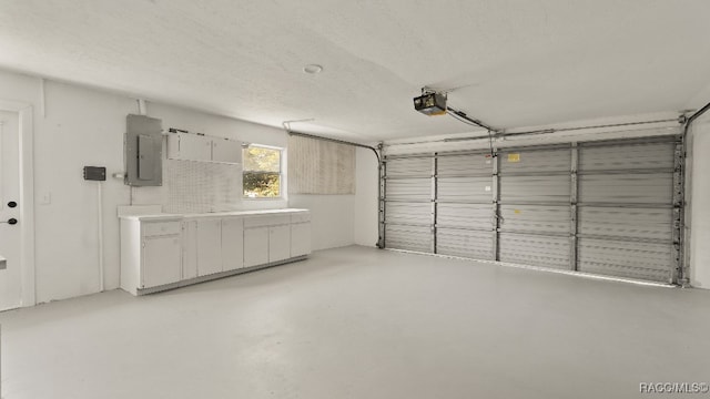 garage with electric panel and a garage door opener