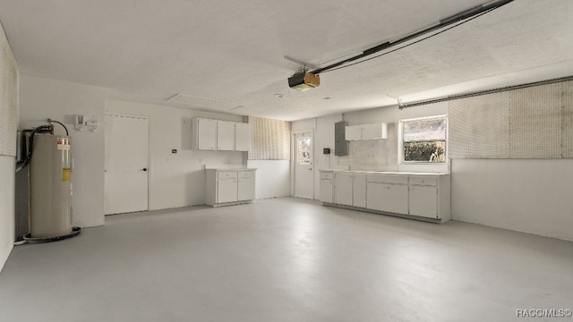 garage featuring electric water heater, electric panel, and a garage door opener