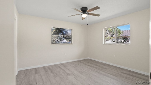 spare room featuring ceiling fan and light hardwood / wood-style floors