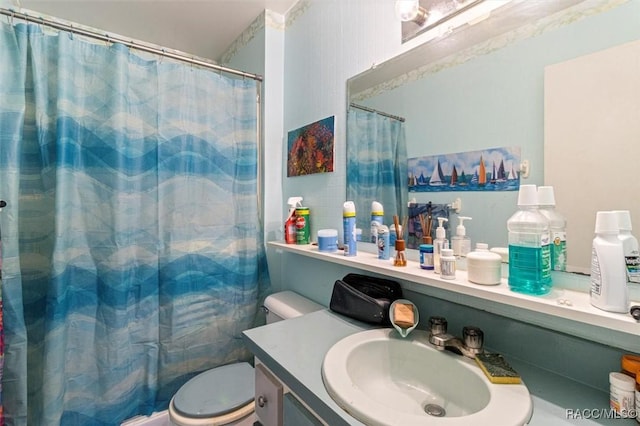 bathroom featuring a shower with curtain, toilet, and vanity