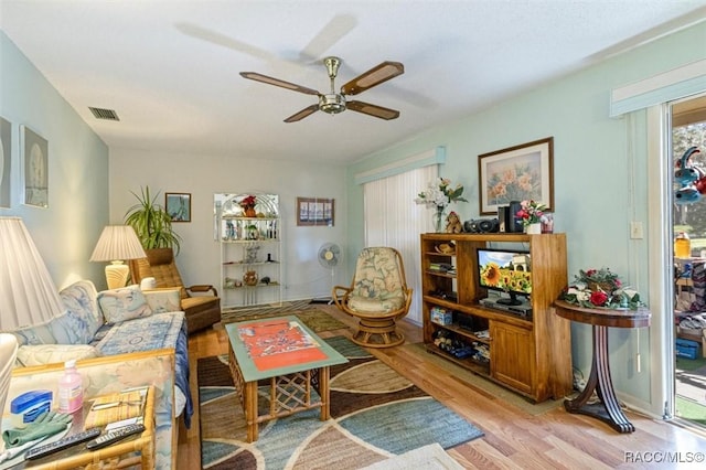 living room featuring ceiling fan and light hardwood / wood-style flooring