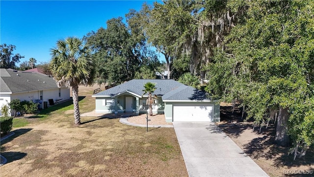 ranch-style home featuring a front lawn and a garage