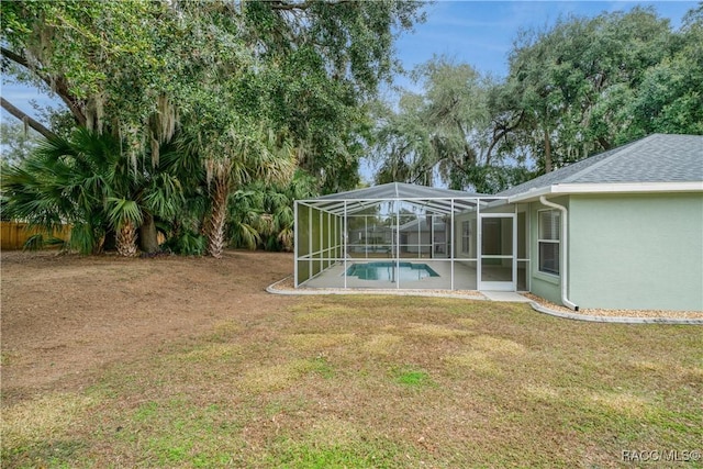 view of yard with glass enclosure