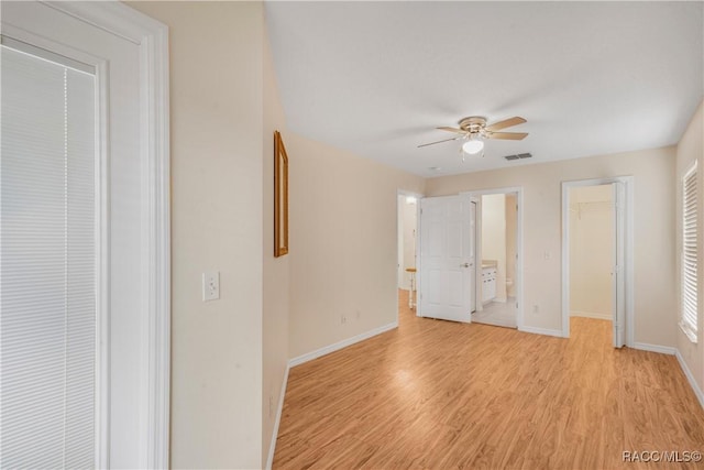 unfurnished bedroom with ceiling fan, light hardwood / wood-style flooring, and ensuite bath