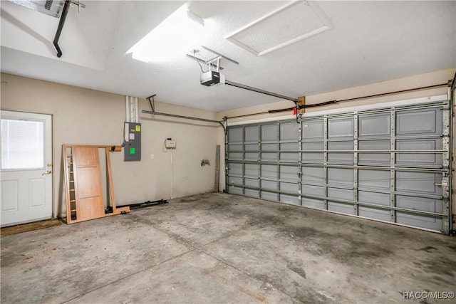 garage with a garage door opener and electric panel