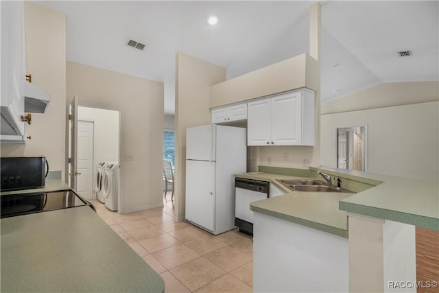 kitchen with separate washer and dryer, white cabinets, black appliances, sink, and kitchen peninsula