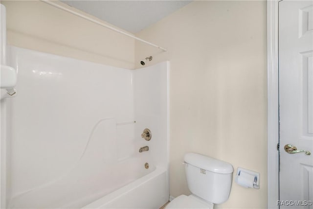 bathroom with shower / bath combination and toilet