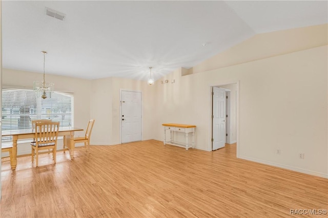 interior space with vaulted ceiling, light hardwood / wood-style flooring, and an inviting chandelier