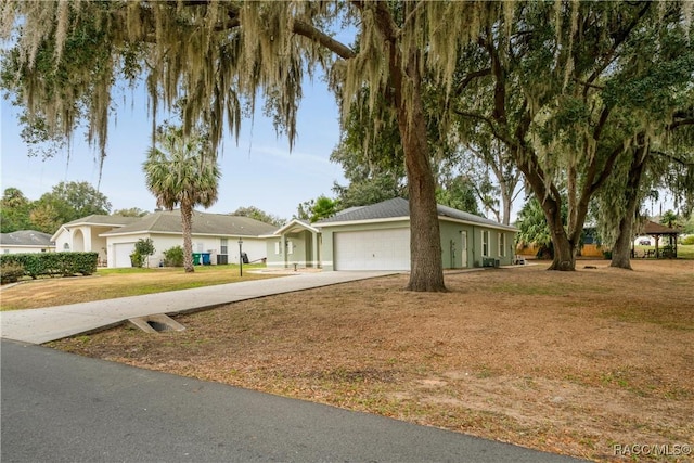 single story home featuring a garage and a front lawn