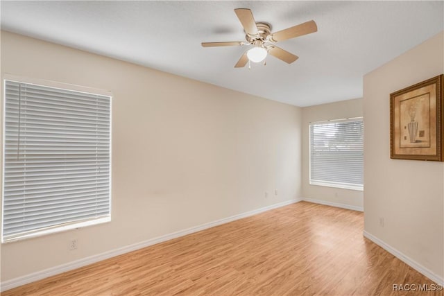 empty room with ceiling fan and light wood-type flooring