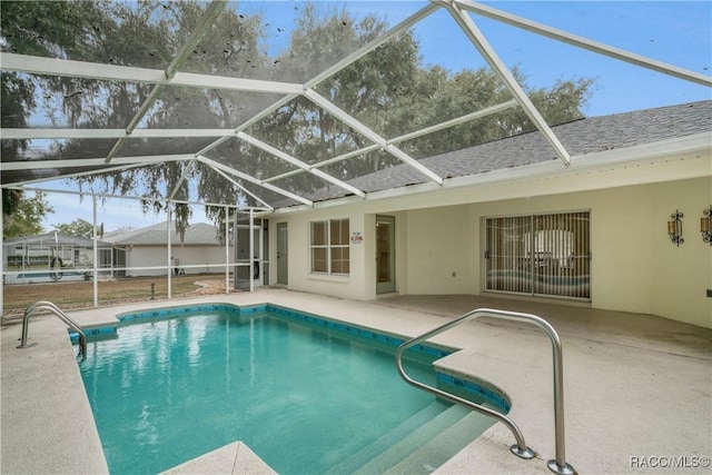 view of swimming pool with a lanai and a patio area