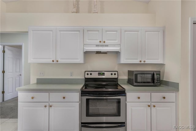 kitchen with light carpet, white cabinets, stainless steel electric stove, and lofted ceiling