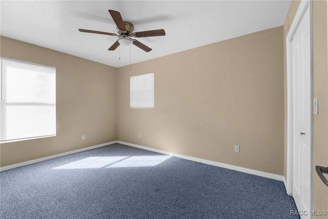 empty room with ceiling fan, carpet, and a healthy amount of sunlight