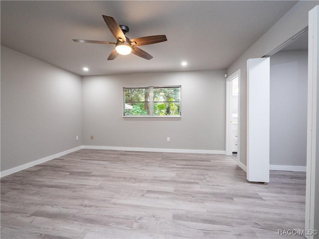 spare room with light hardwood / wood-style floors and ceiling fan