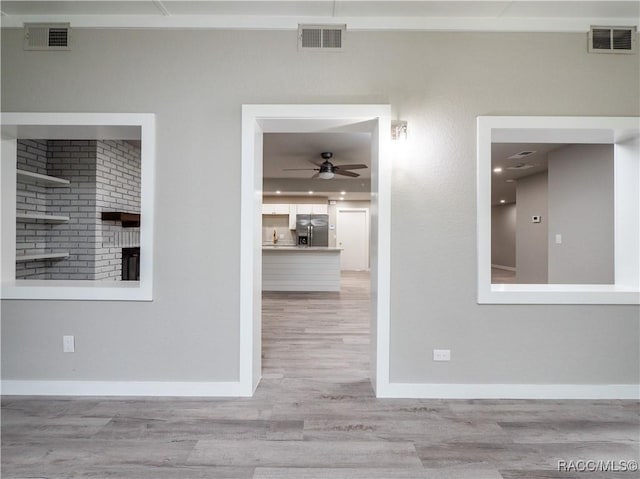 interior space with light hardwood / wood-style floors and ceiling fan