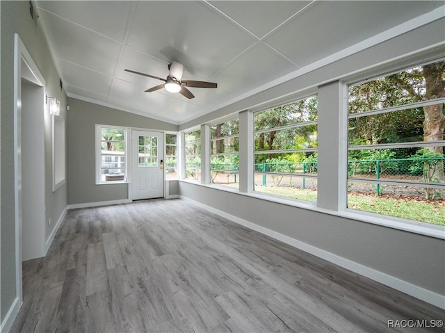 unfurnished sunroom featuring ceiling fan