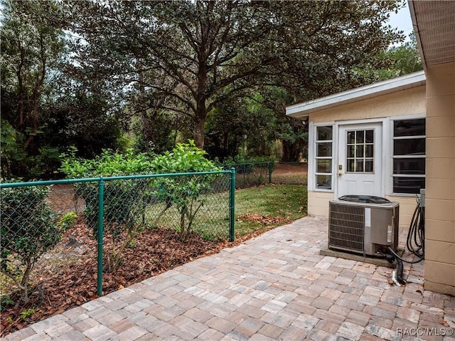 view of patio / terrace with an outbuilding and central AC