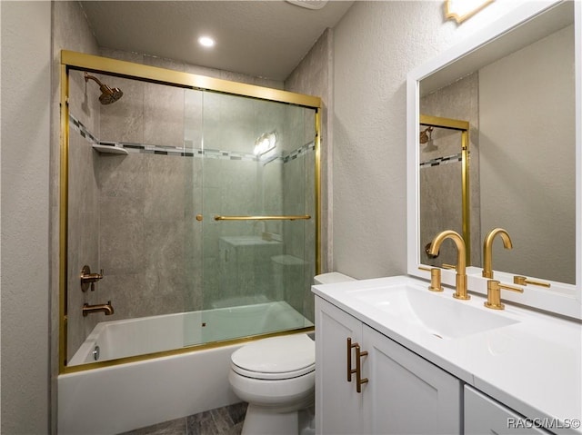 full bathroom featuring bath / shower combo with glass door, toilet, and vanity