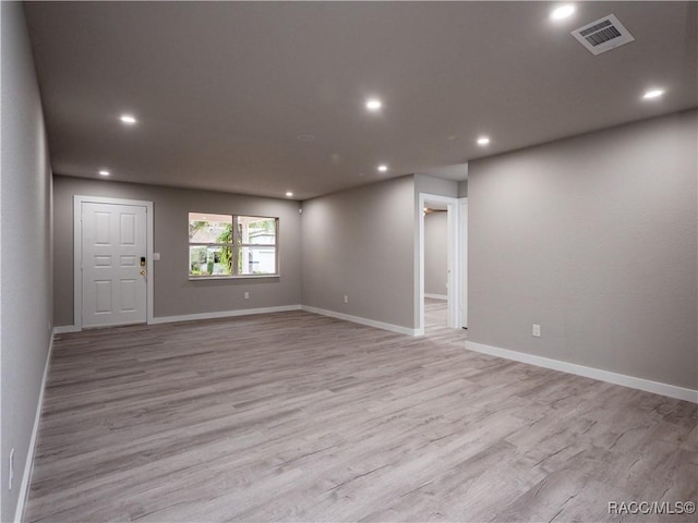 unfurnished room featuring light hardwood / wood-style floors