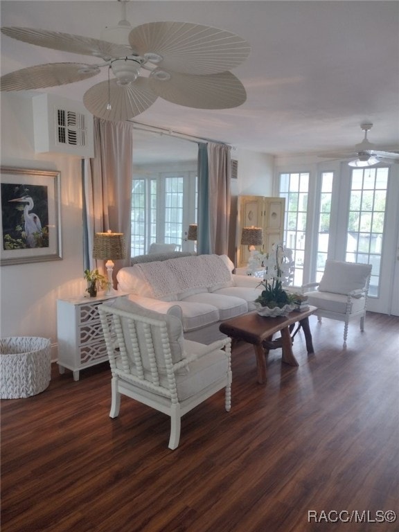 living room featuring ceiling fan and dark wood-type flooring