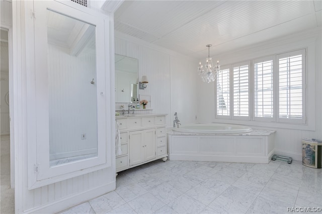 bathroom with a bath, a chandelier, vanity, and a healthy amount of sunlight