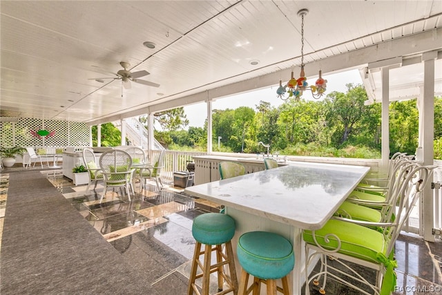 sunroom featuring plenty of natural light and ceiling fan