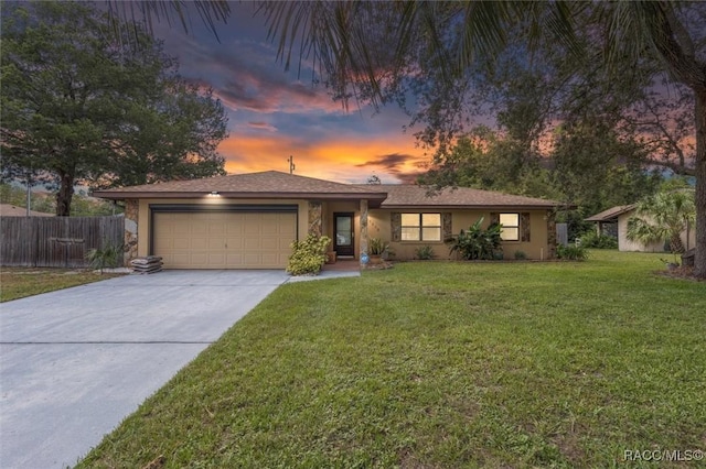 9858 N Cortlandt Dr, Citrus Springs, FL 34434 - view of front facade featuring a garage, concrete driveway, and stucco siding