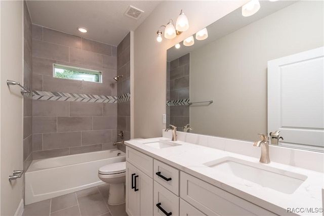 full bathroom with vanity, tile patterned floors, tiled shower / bath combo, and toilet